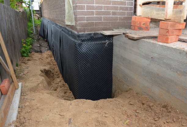 SJ Waterproofing Pros technician performing targeted Wet Basement Repair assessment in Holtsville, NY